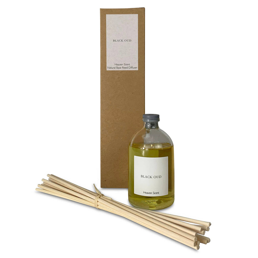 Aromatherapy diffuser set with bottle, reeds, and packaging on a white background