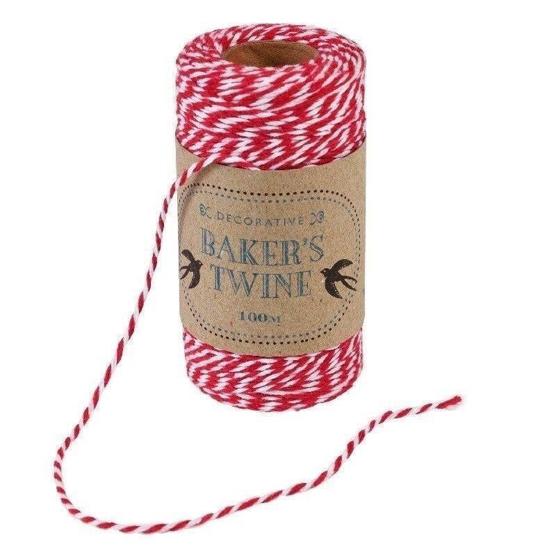 Spool of red and white baker's twine with a decorative label on a white background