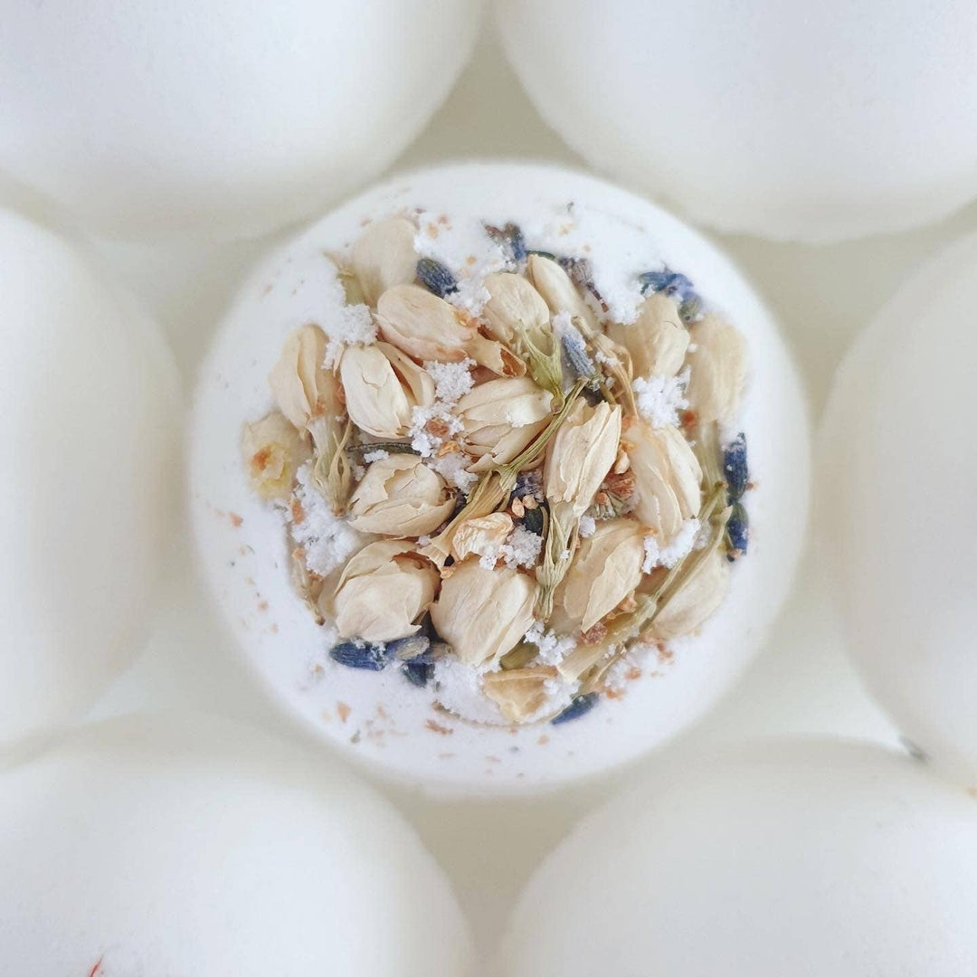 Bath bomb with oats and blueberries on a white background