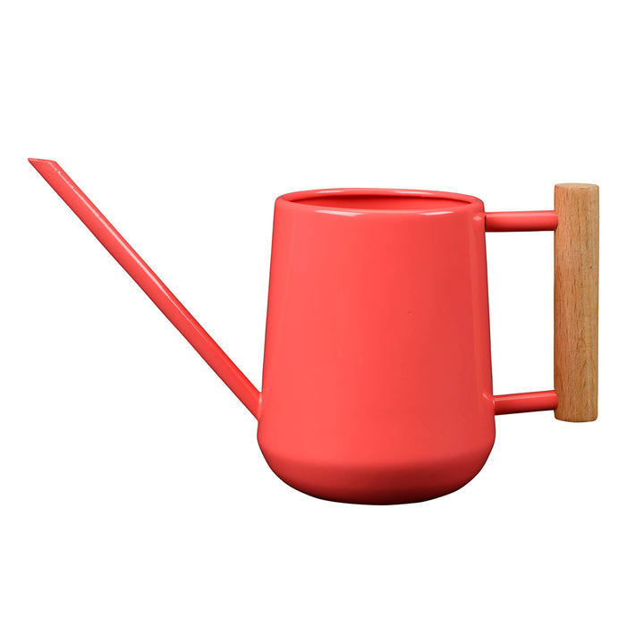 Coral watering can with a wooden handle on a white background