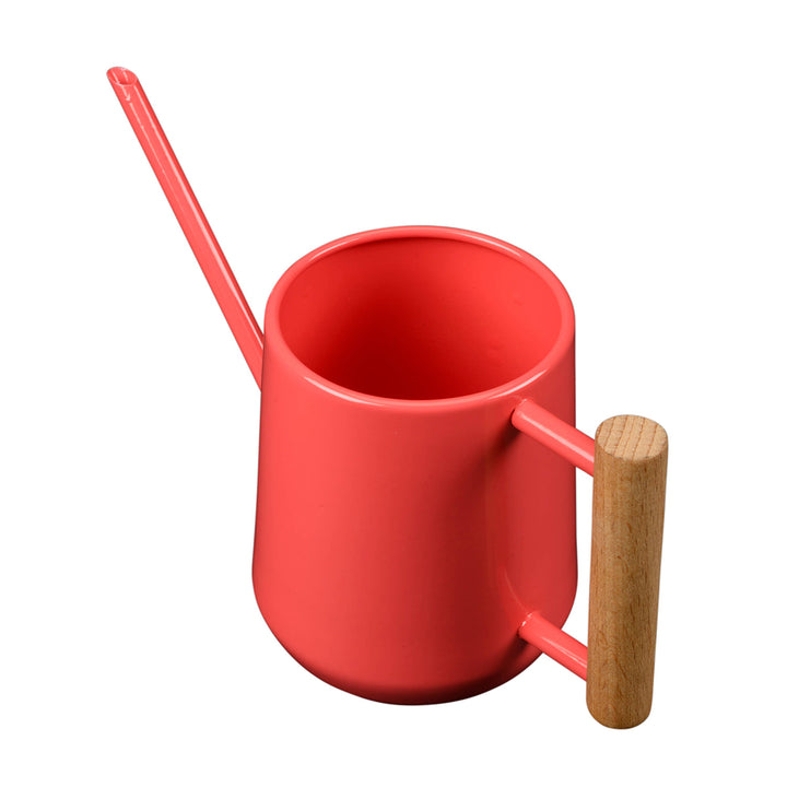 Coral watering can with a wooden handle on a white background
