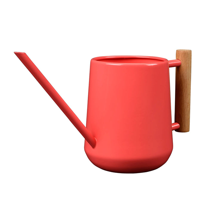Coral watering can with a wooden handle on a white background