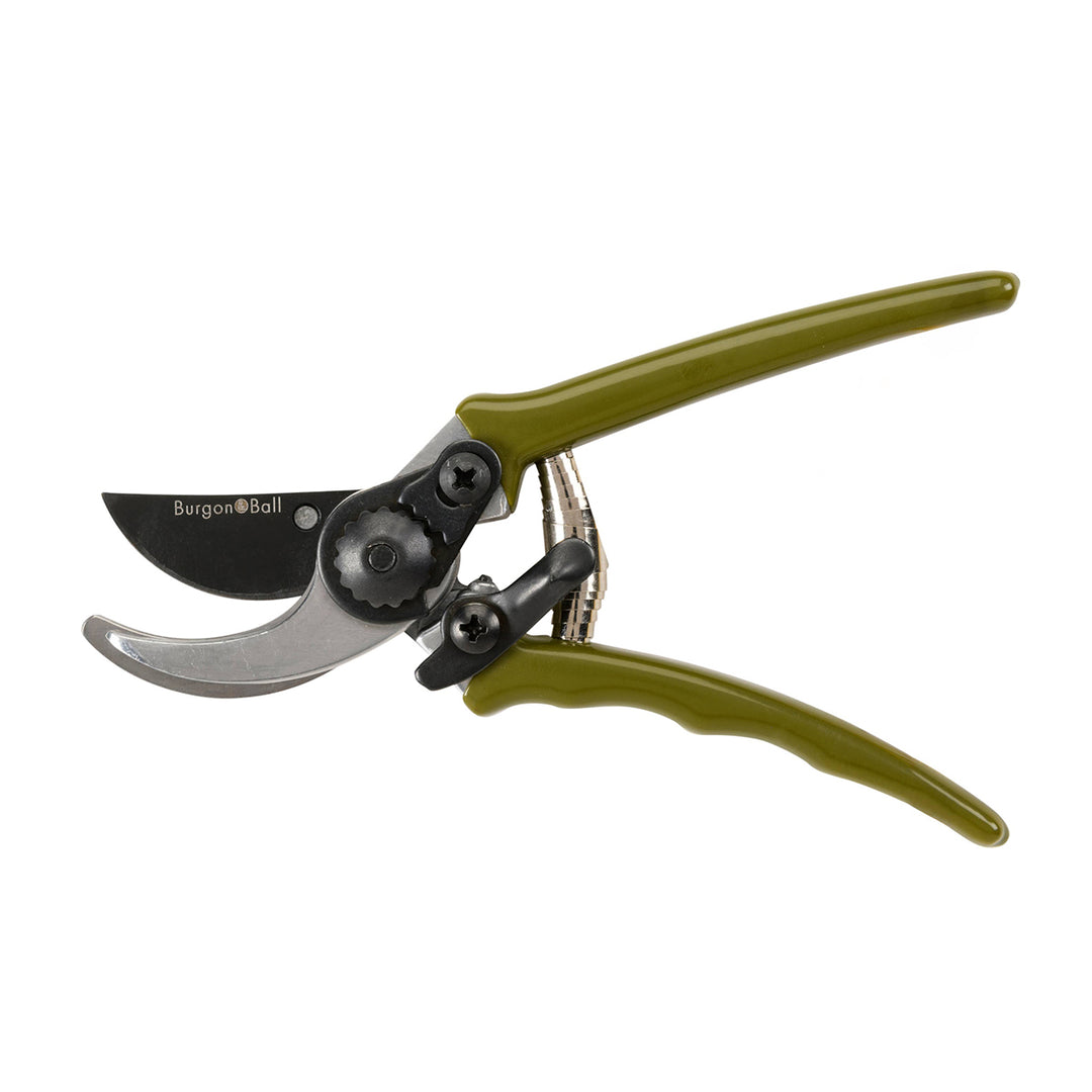 Gardening pruner with green handles on a white background