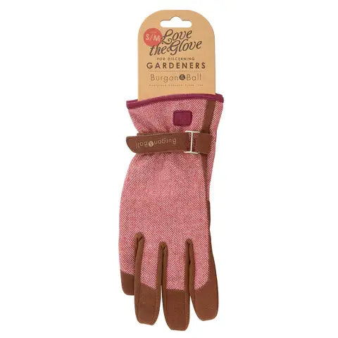 Red gardening glove with brown accents on a white background