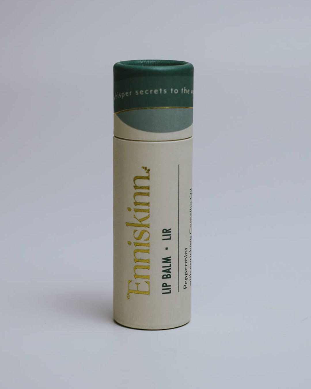 Enniskinn lip balm container on a light gray background