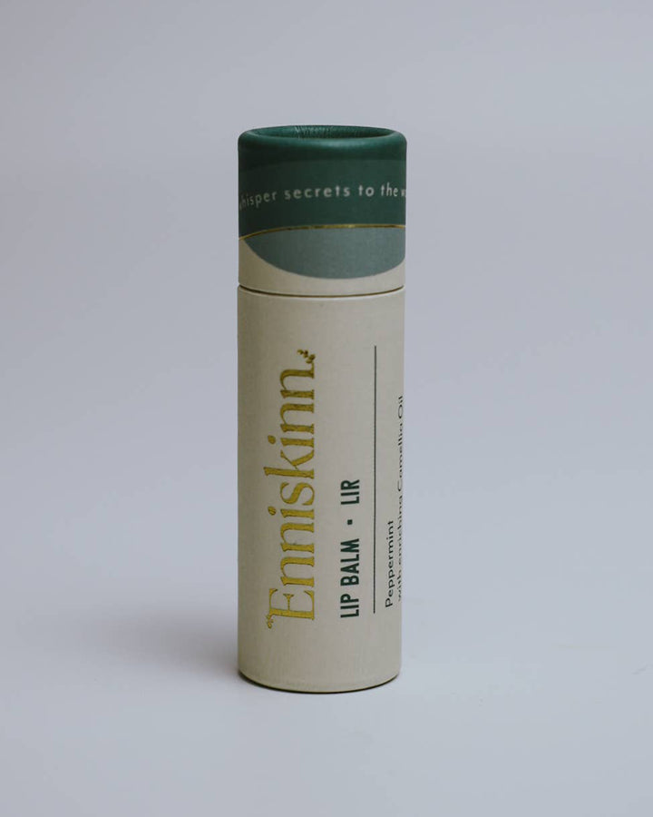 Enniskinn lip balm container on a light gray background