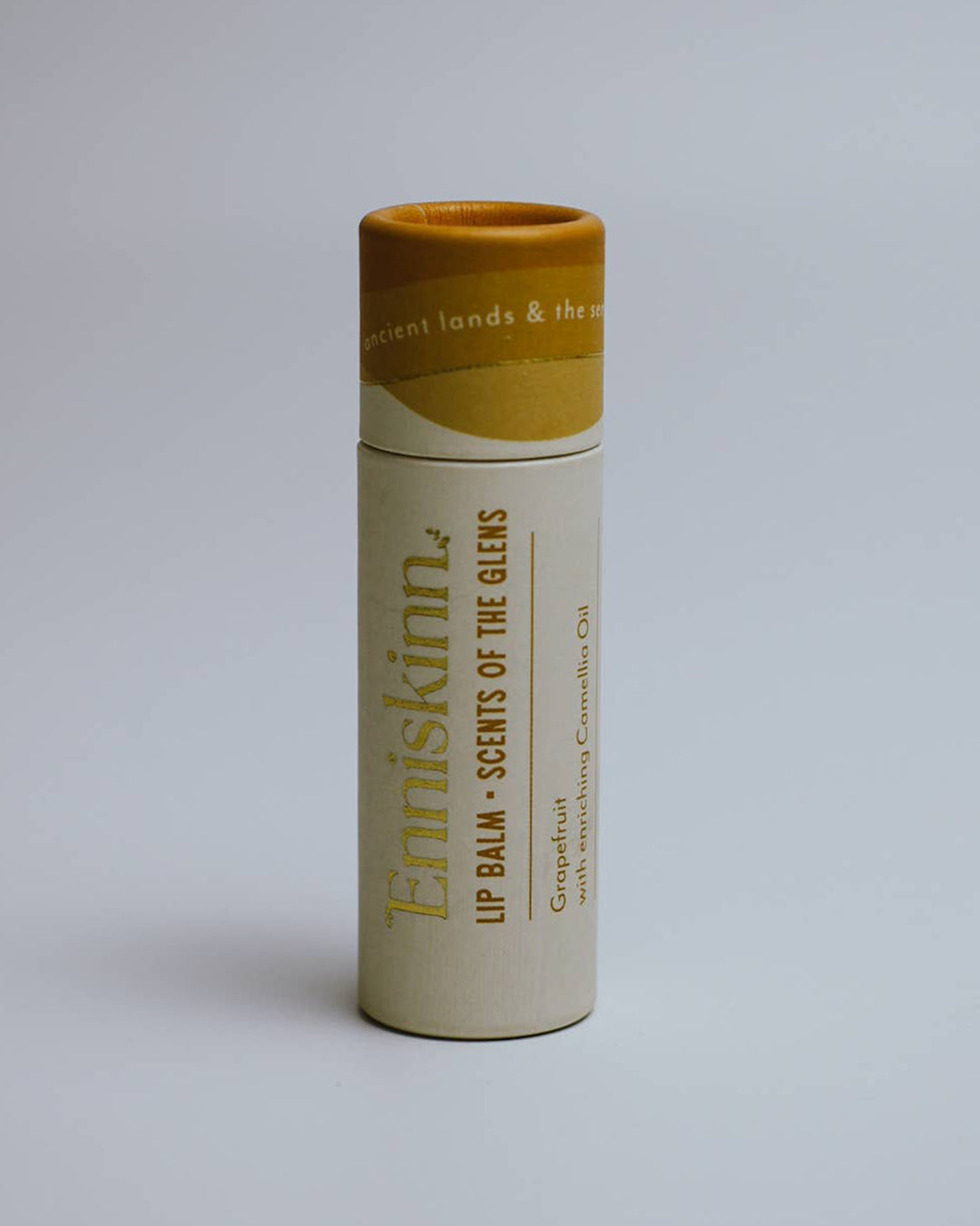 Lip balm container with 'Erniskinn' branding on a light gray background