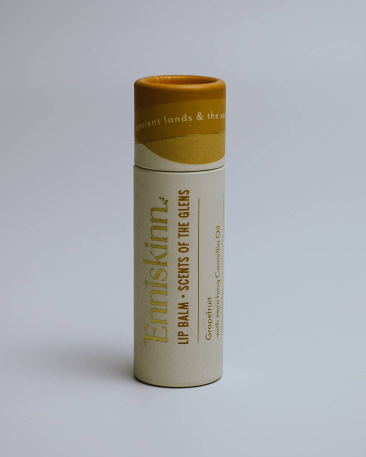 Lip balm container with 'Erniskinn' branding on a light gray background
