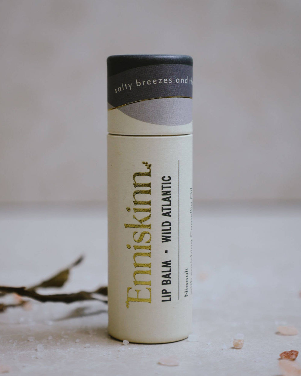 Enniskinn lip balm tube on a neutral background