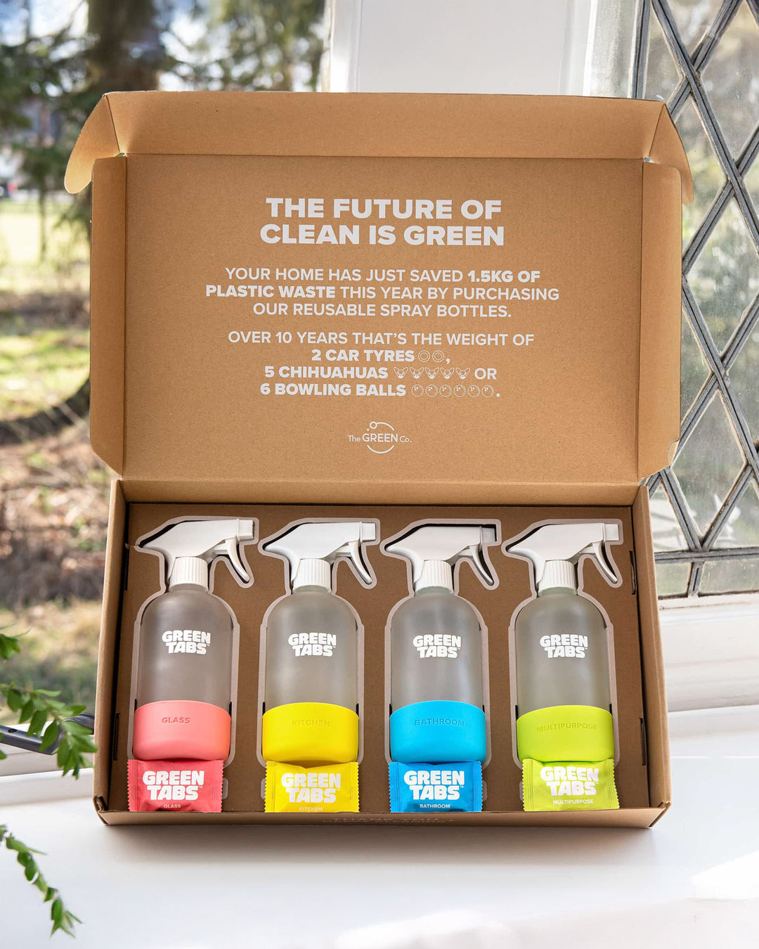 Set of four spray bottles with colorful nozzles in a 'Green Tabs' box, featuring sustainability text.