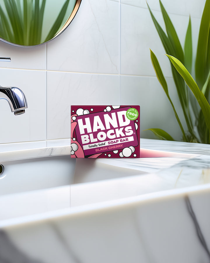 Hand Blocks soap bar packaging on a bathroom sink with plants in the background