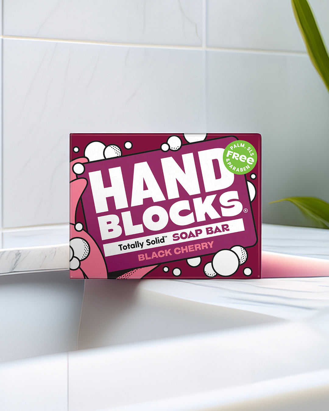 Hand Blocks soap bar packaging on a bathroom shelf with a tiled wall background