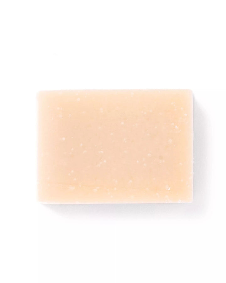 Beige soap bar on a white background