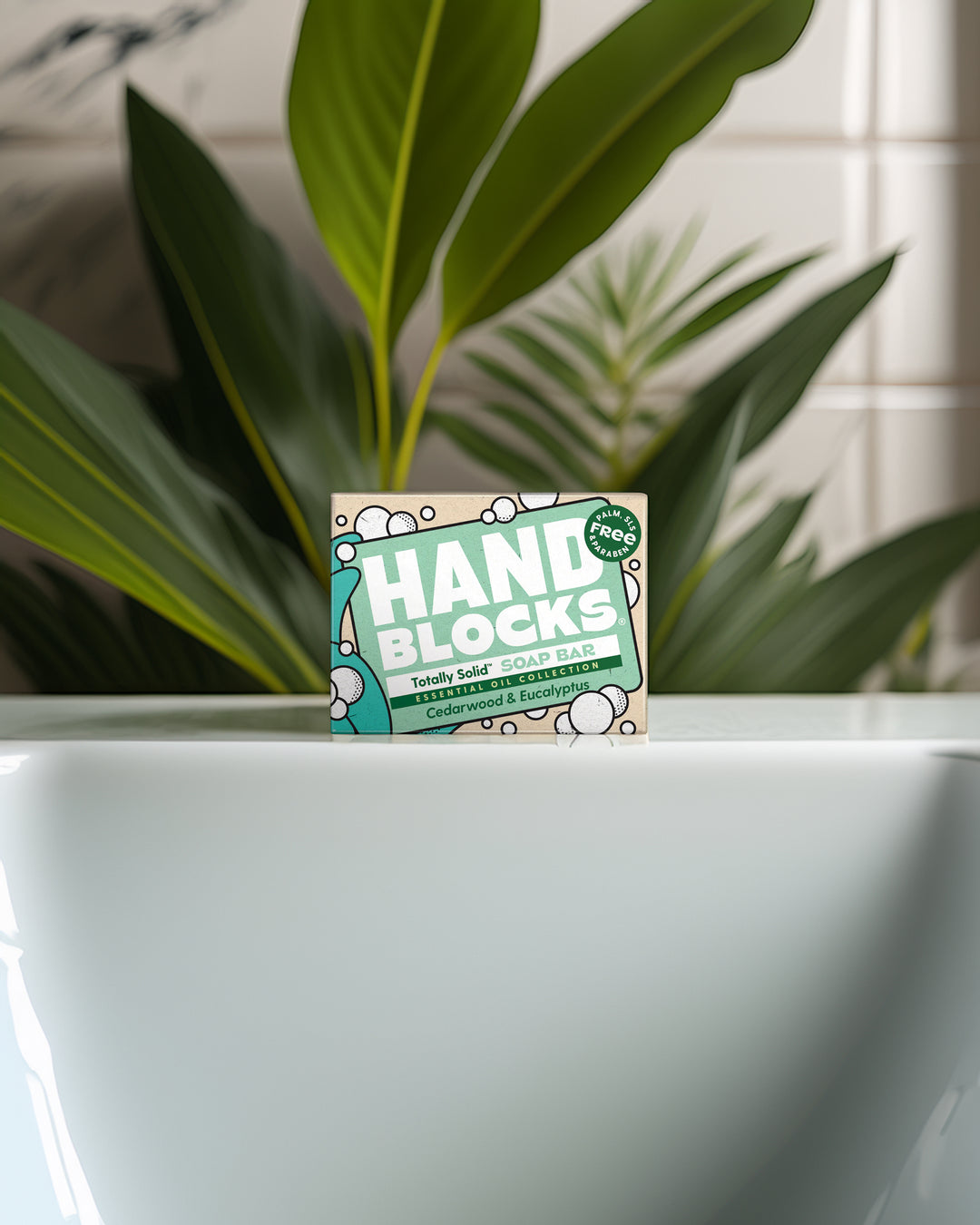 Hand Blocks packaging in front of a plant