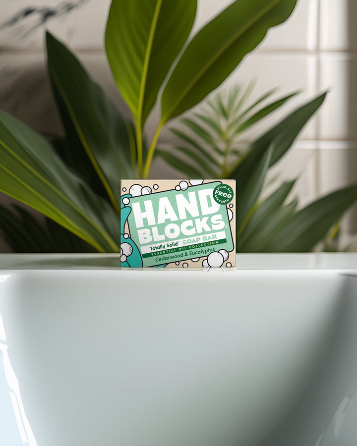 Hand Blocks packaging in front of a plant