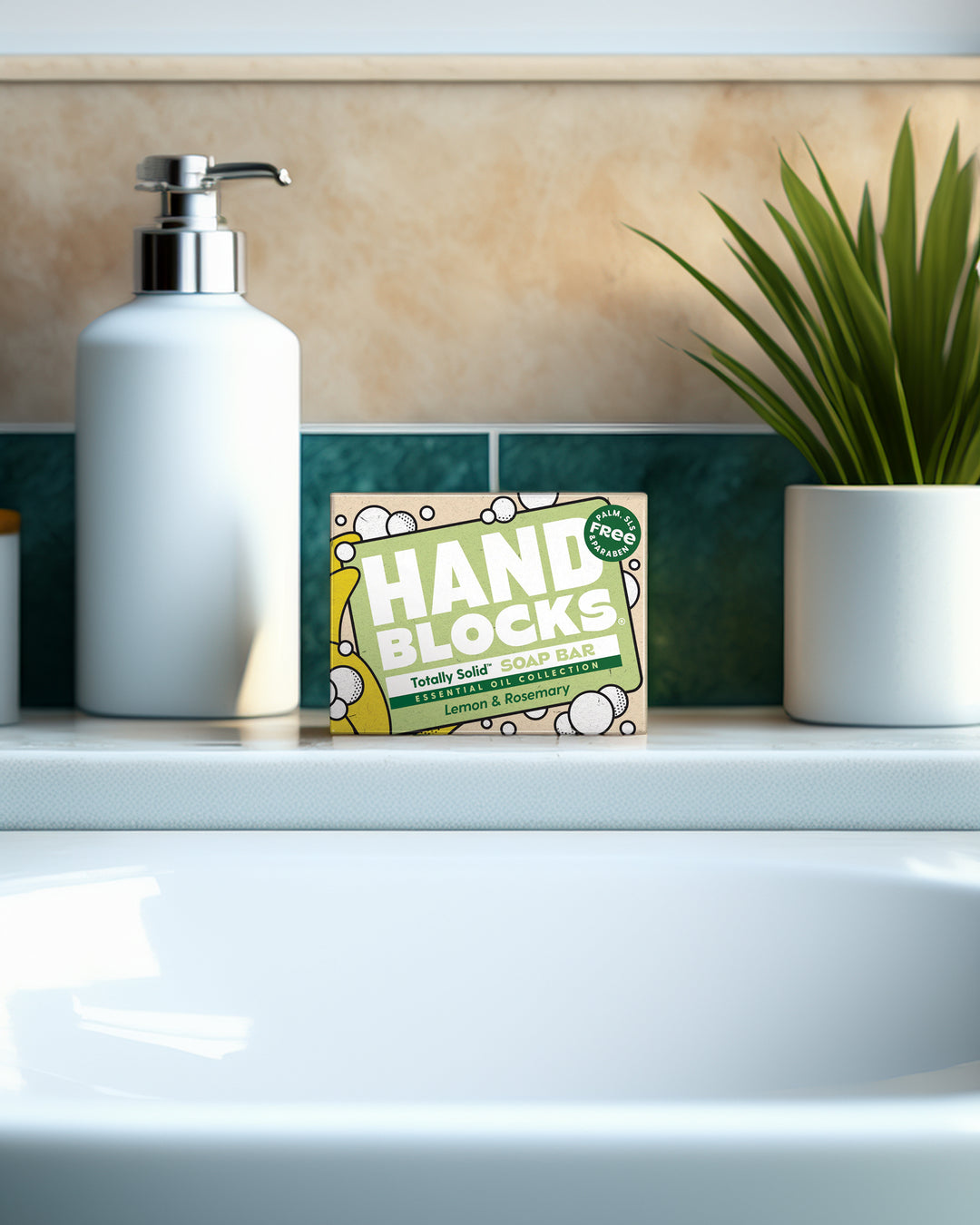 Hand Blocke soap bar on a bathroom counter with a dispenser and plant in the background