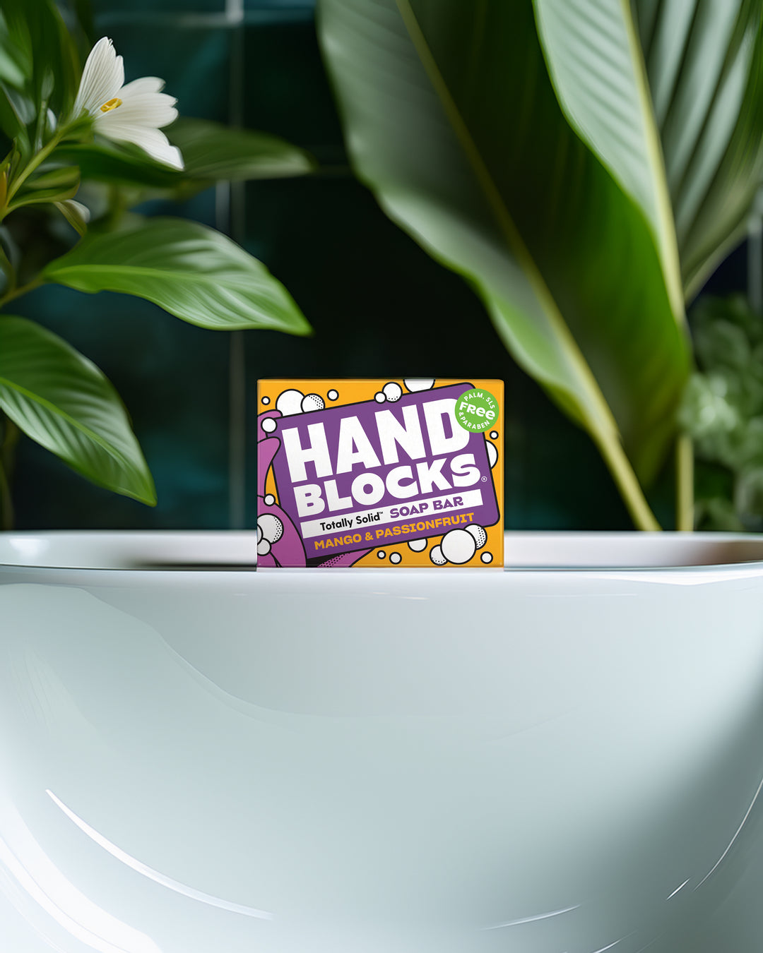 Hand Blocks soap bar packaging on a white surface with green plants in the background
