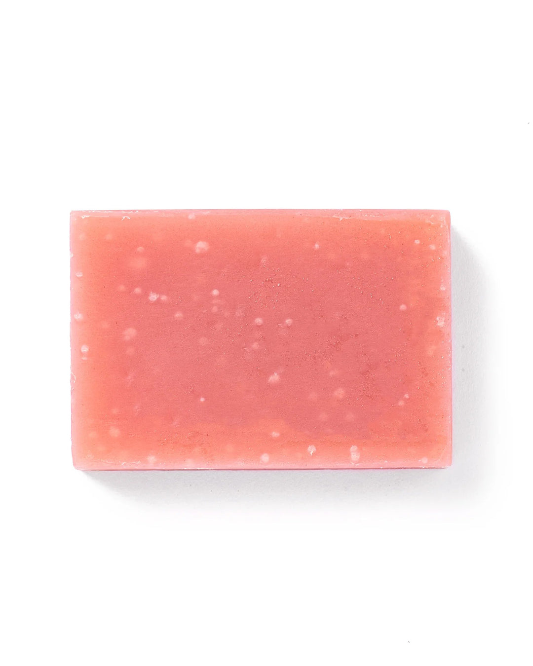 Rectangular pink soap bar with speckles on a white background
