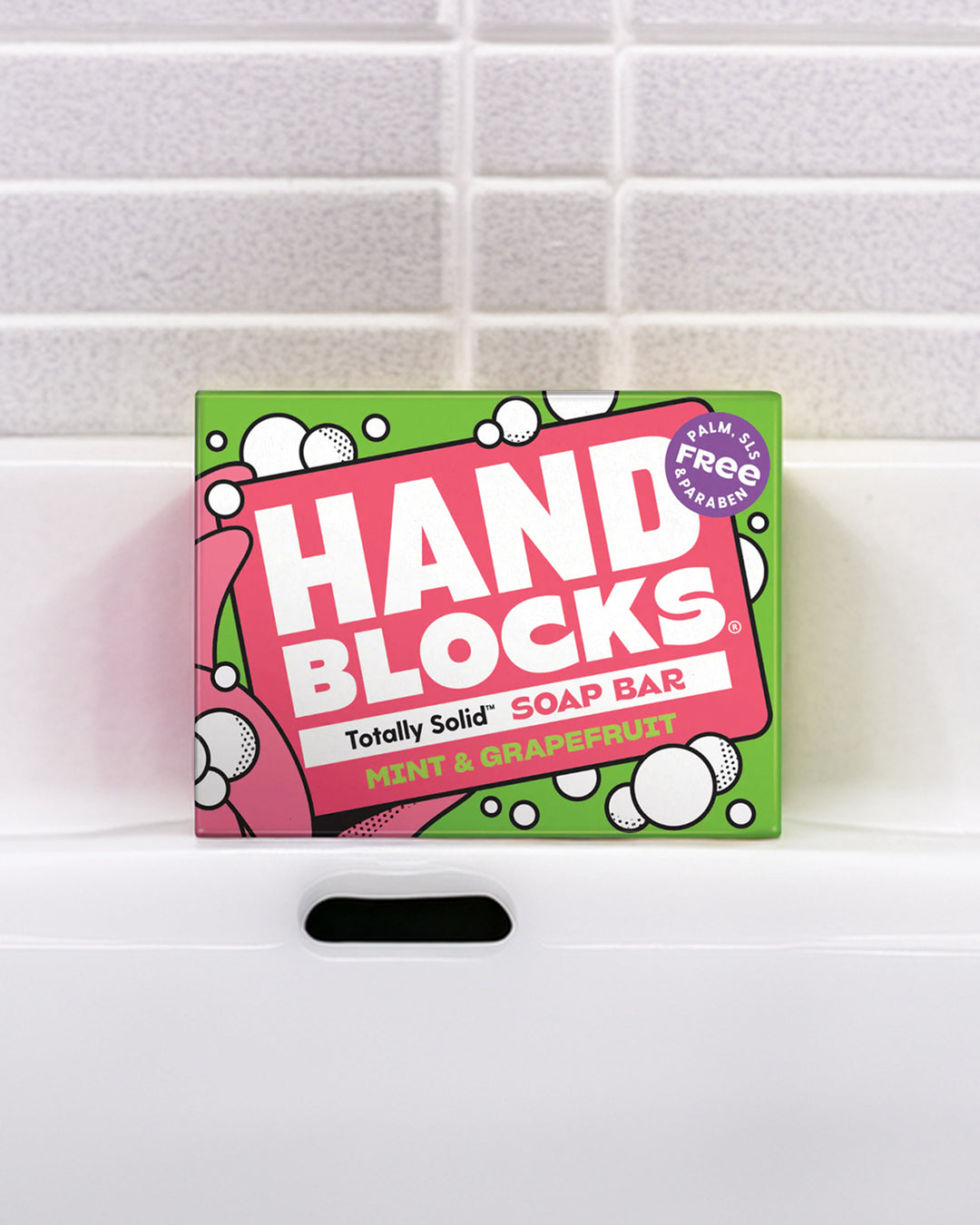 Box of Hand Blocks soap bar on a tiled bathroom shelf