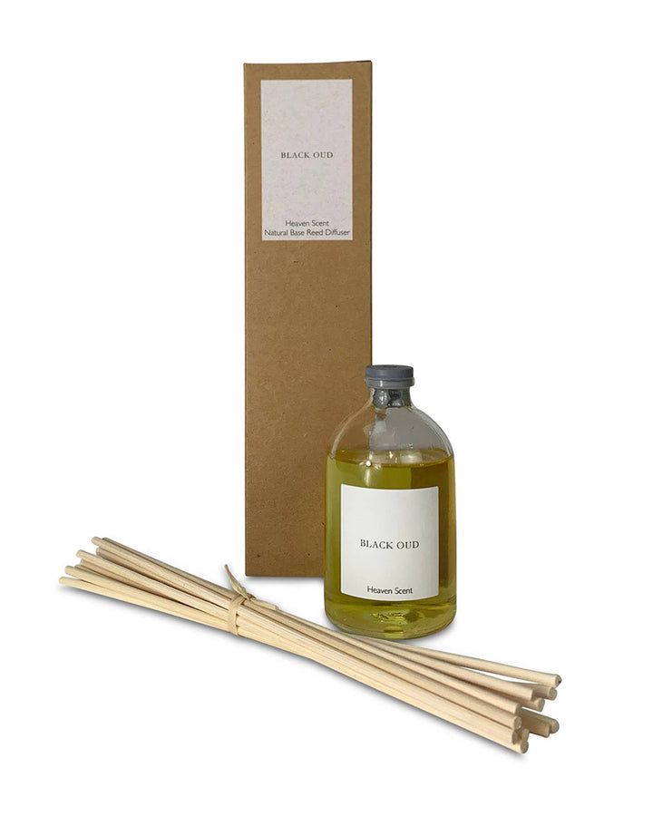 Aromatherapy diffuser set with bottle, reeds, and packaging on a white background