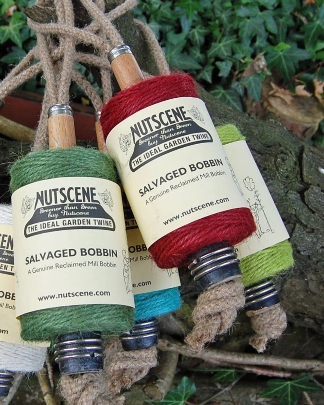 NUTSCENE salvaged bobbin with green and red yarn on a natural background