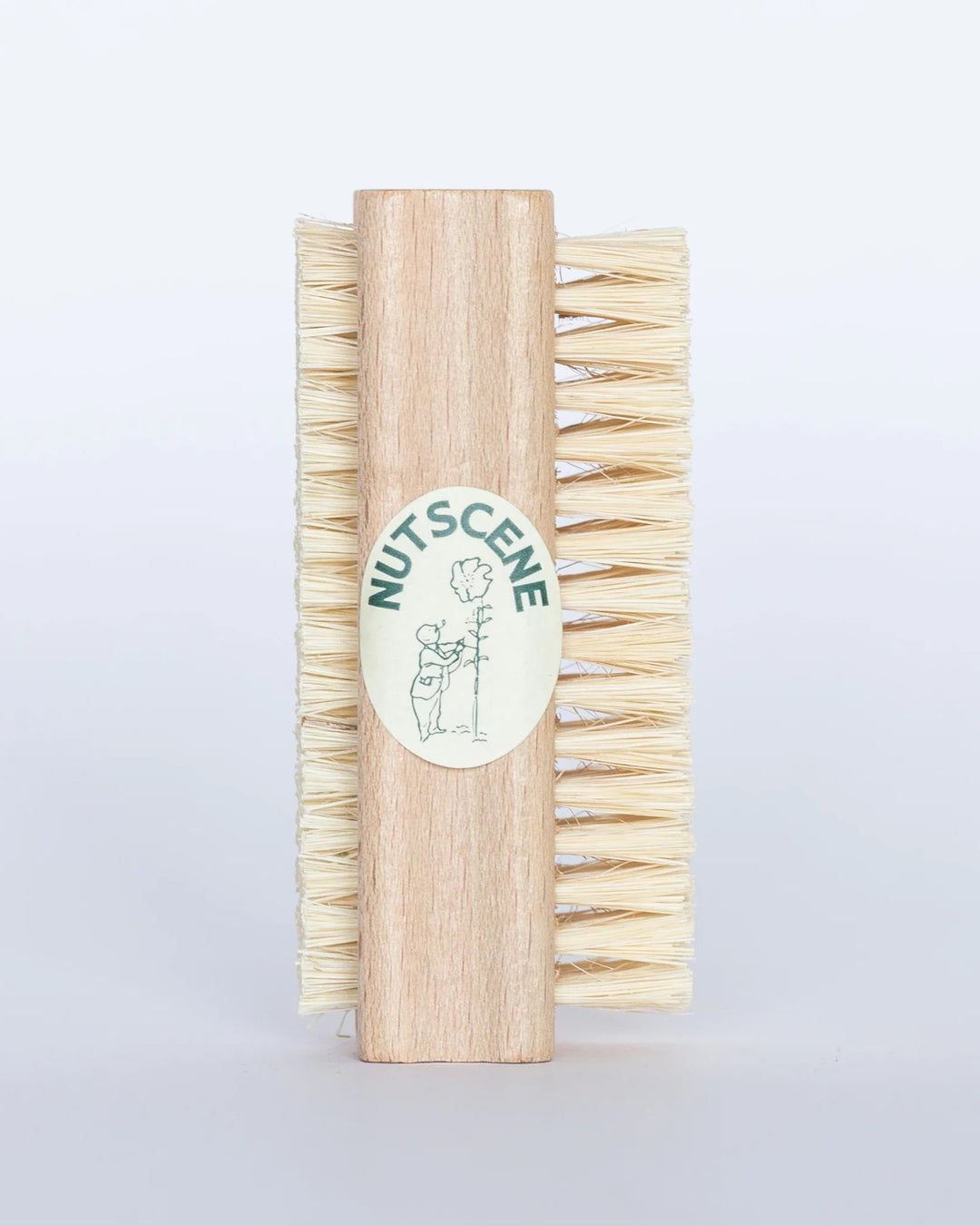 Wooden brush with bristles and a visible brand logo on a light gray background