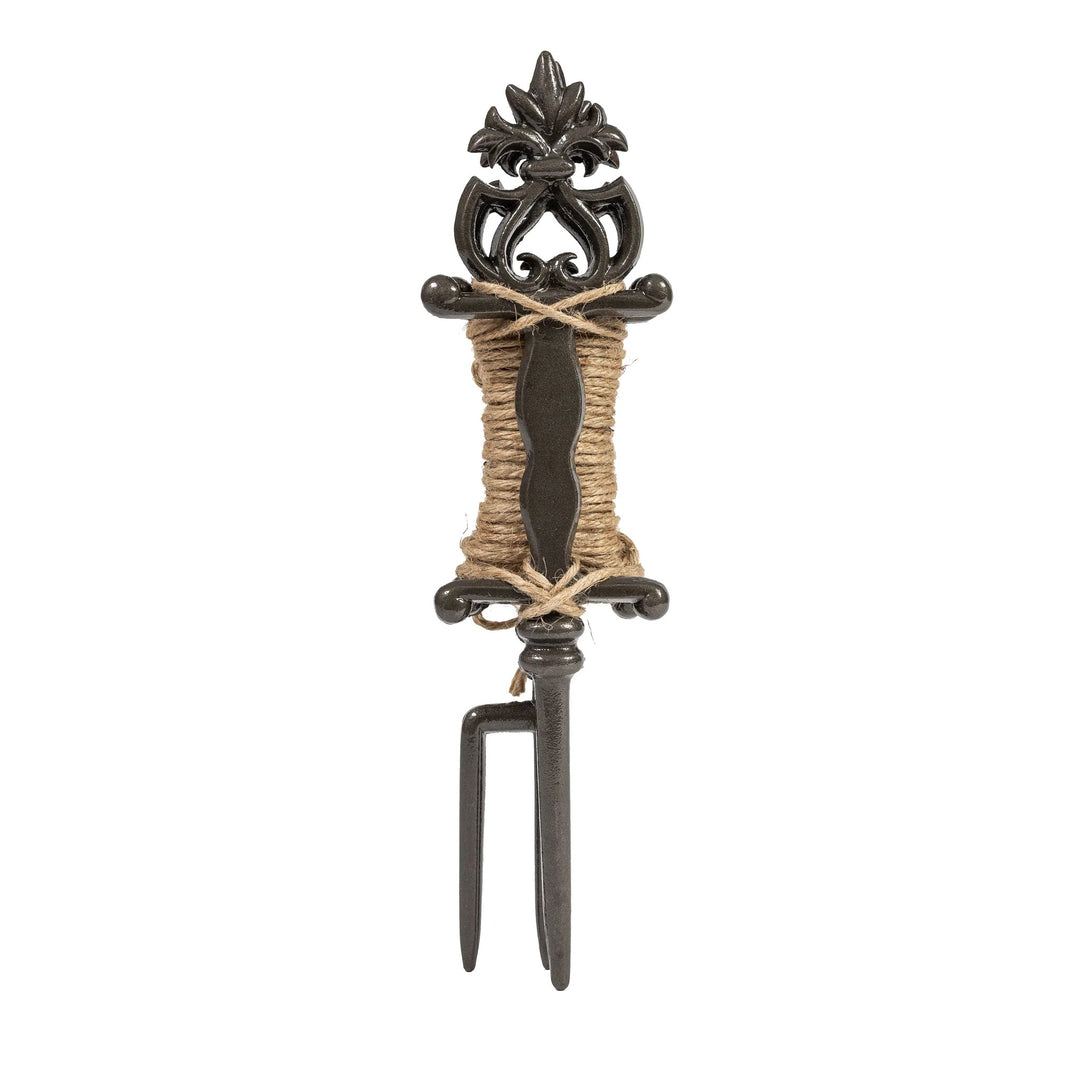 Decorative metal tool with a decorative handle on a white background