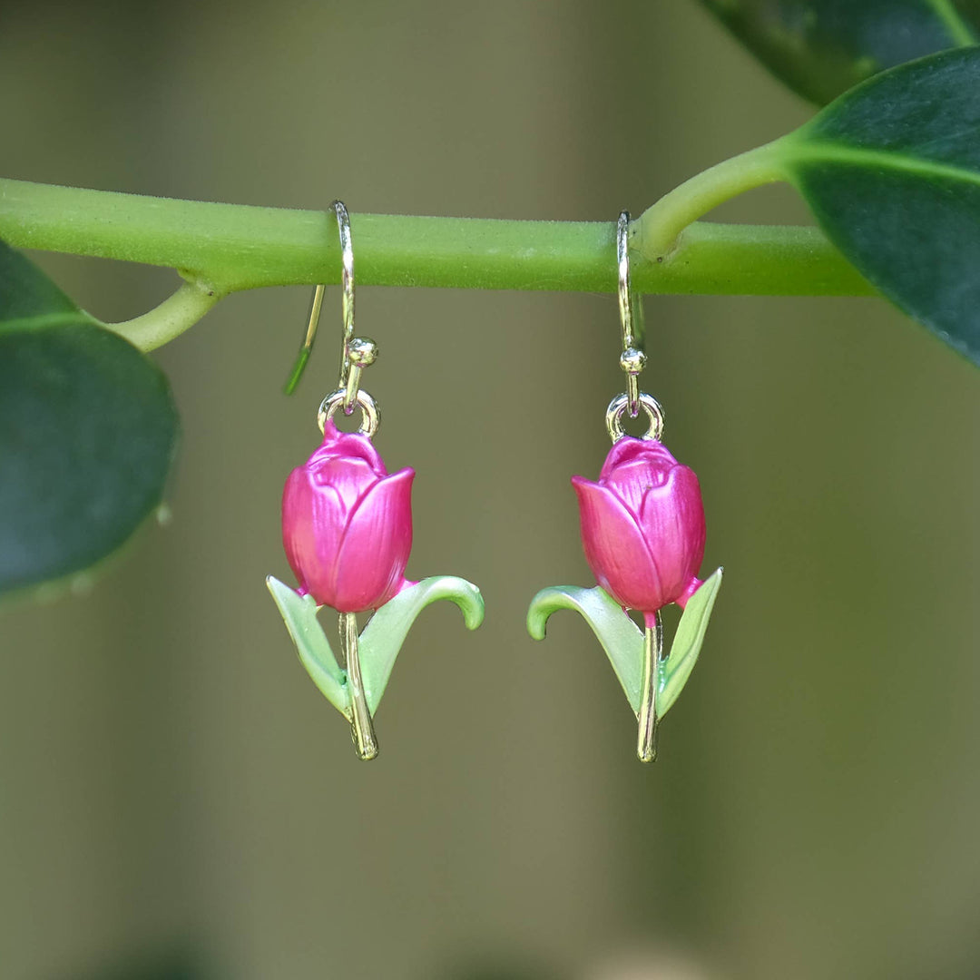 Pink tulip-shaped earrings hanging on a green stem with leaves.