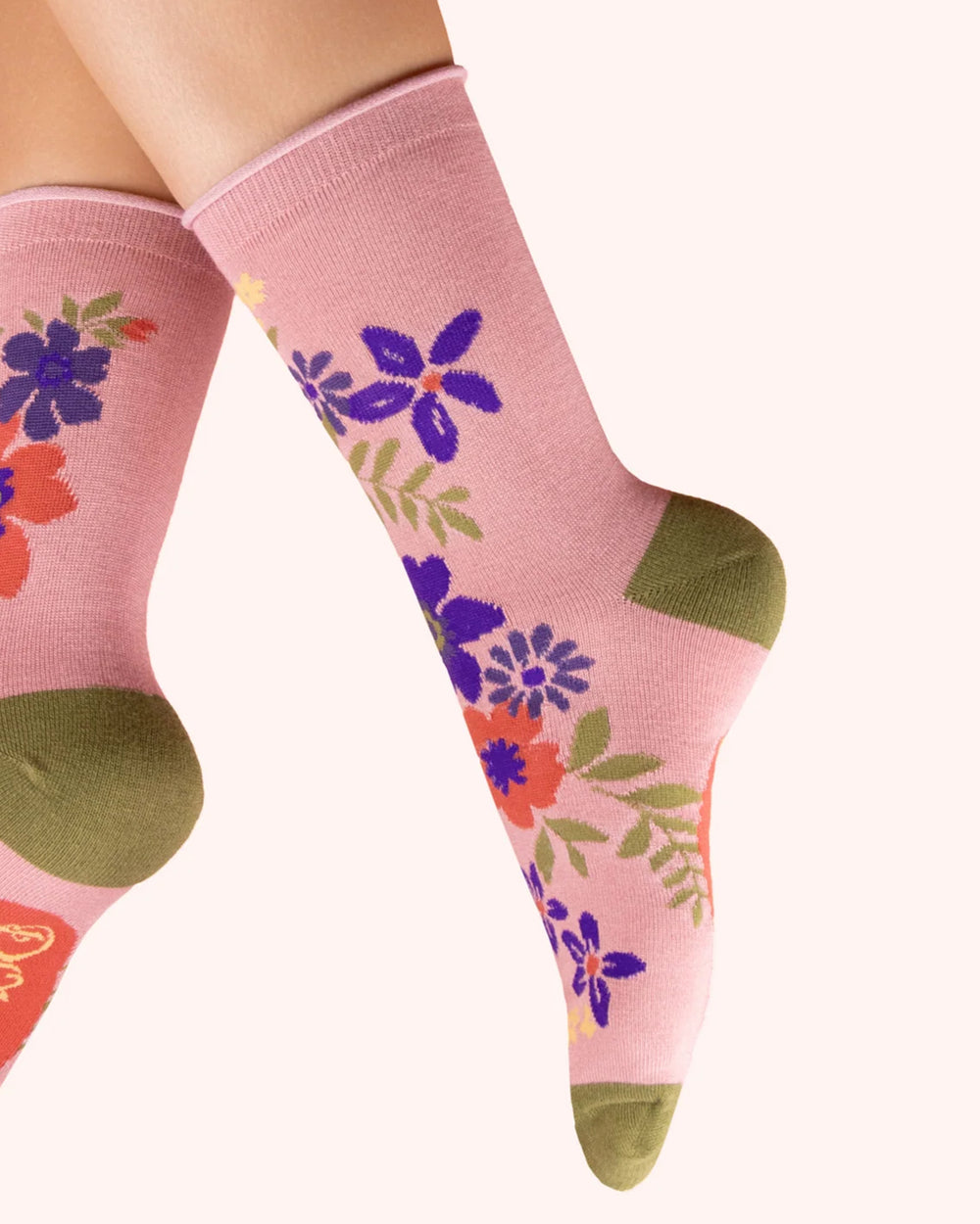 Pink socks with floral patterns on a white background