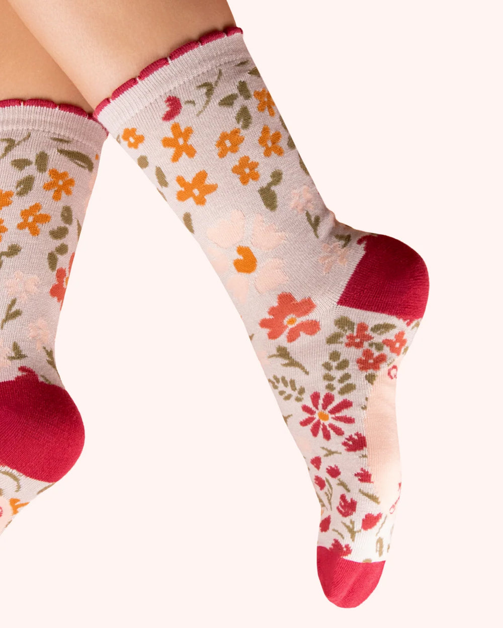 Floral patterned socks with red accents on a white background