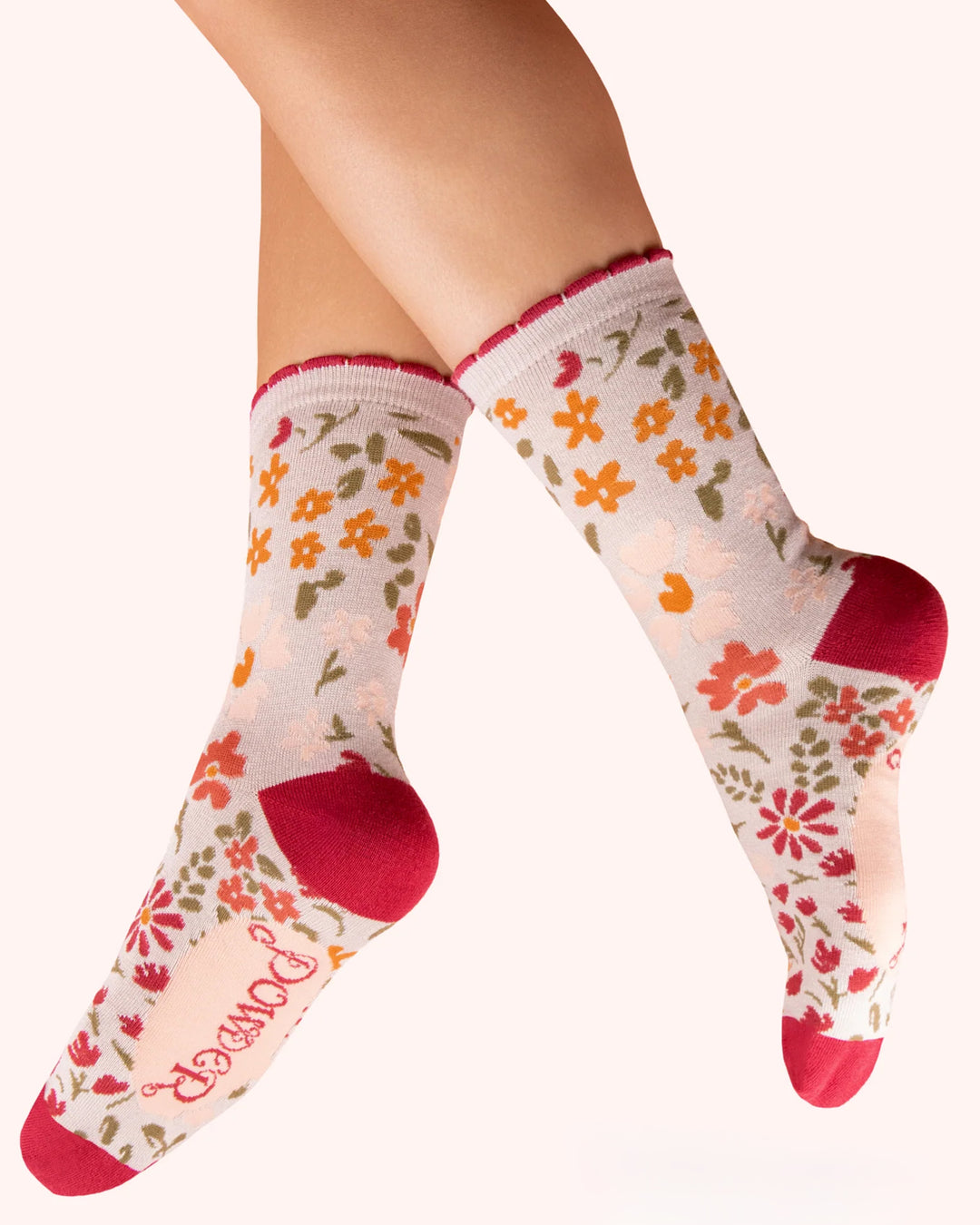 Floral patterned socks with red accents on a white background