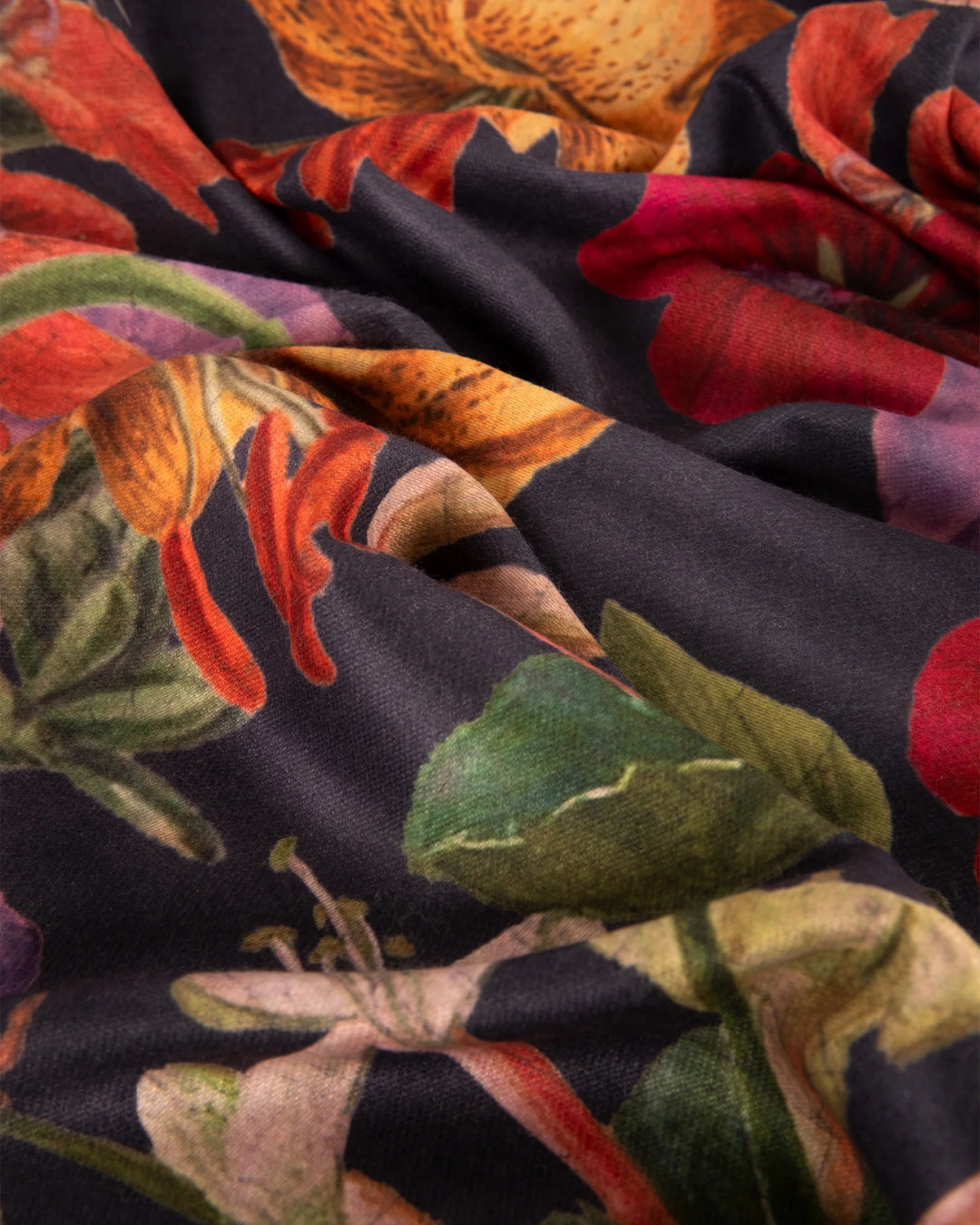 Close-up of colorful floral fabric with dark background