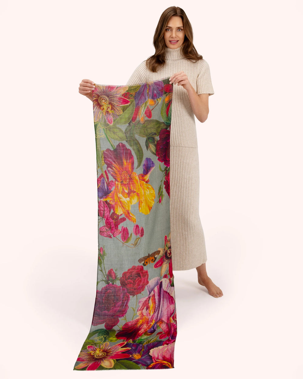 Woman holding a colorful floral scarf on a white background