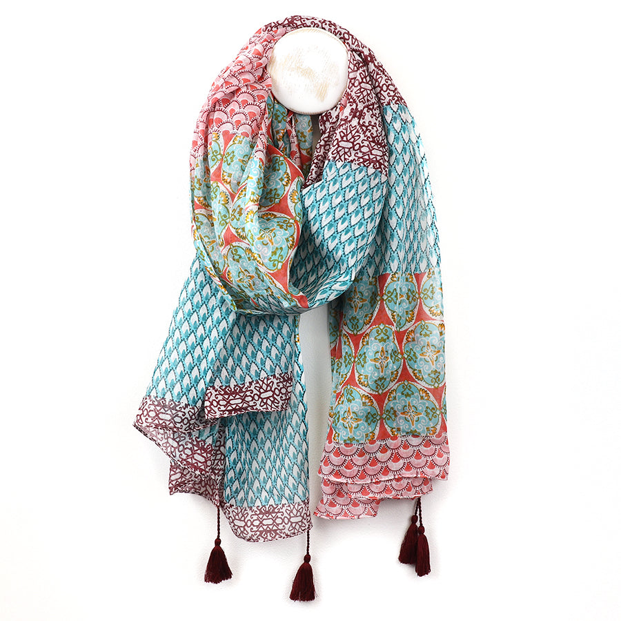 Colorful patterned scarf with tassels on a white background