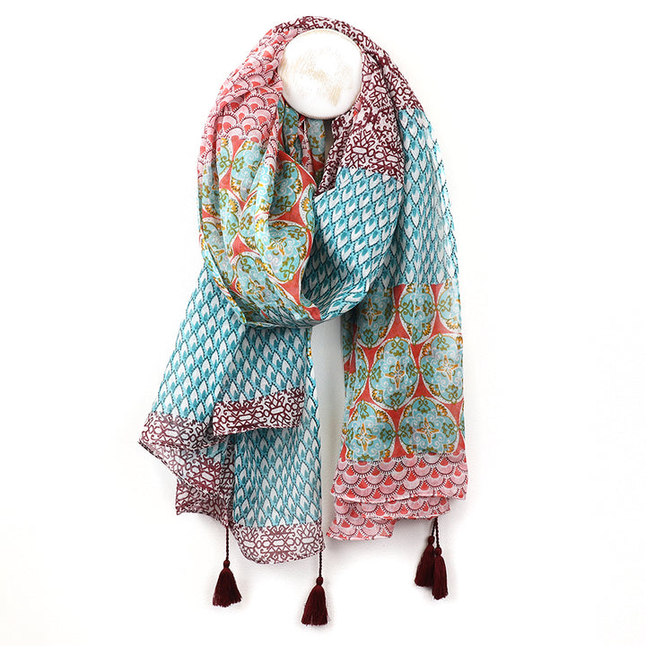 Colorful patterned scarf with tassels on a white background