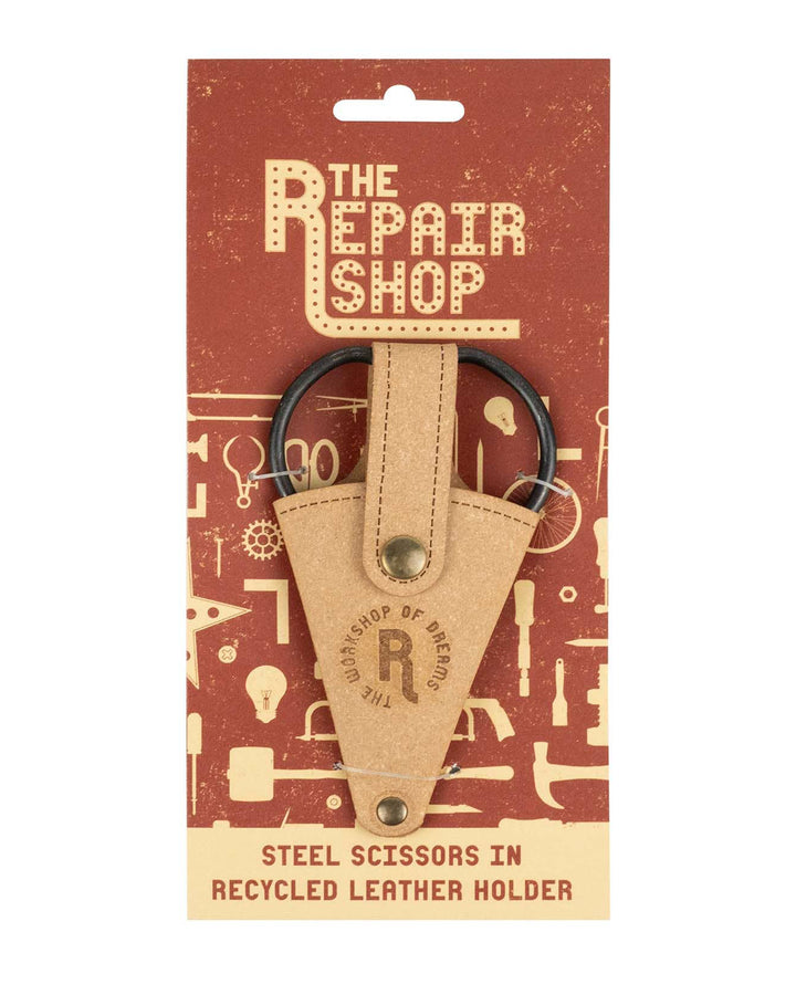 Steel scissors in a recycled leather holder on 'The Repair Shop' packaging.