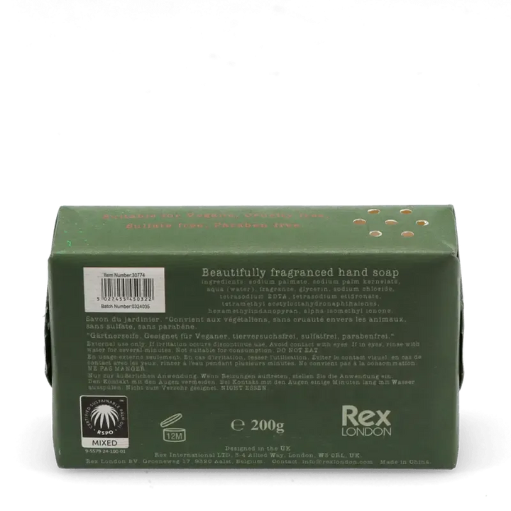 Unwrapped Rustic Fields soap bar beside its illustrated packaging