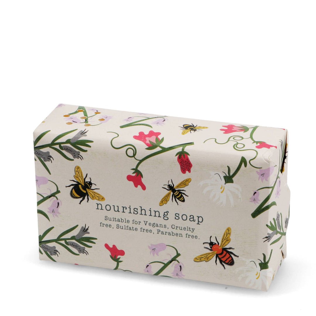 Bar of soap with floral and bee design on a white background