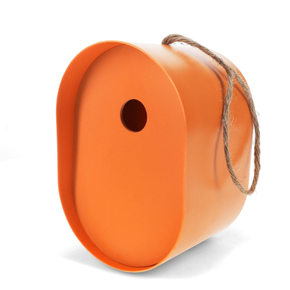 Orange birdhouse with a string on a white background