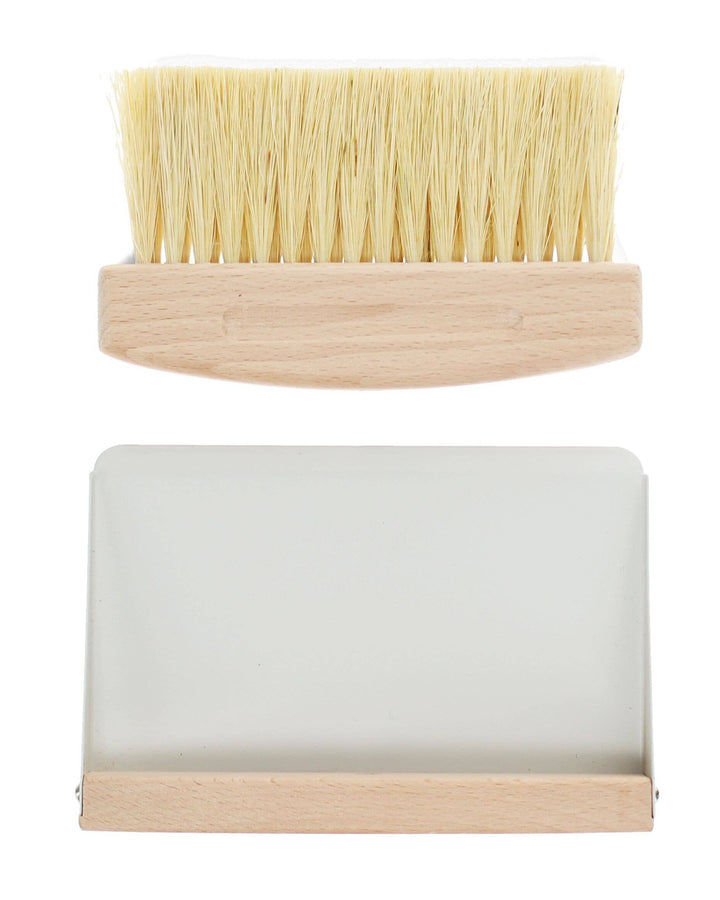 Bristle brush and soap dish with wooden base on a white background