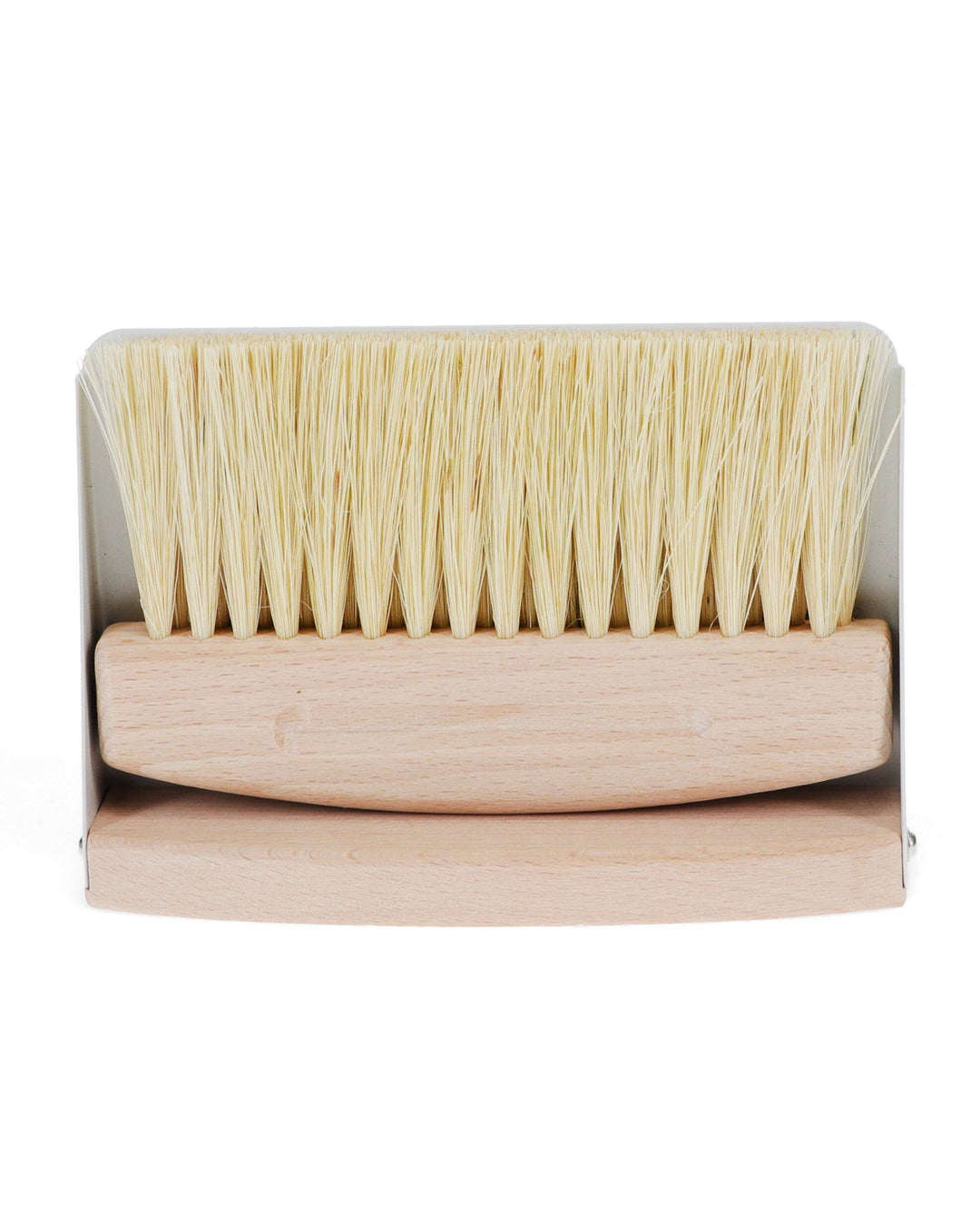 Wooden brush with bristle head in packaging on a white background