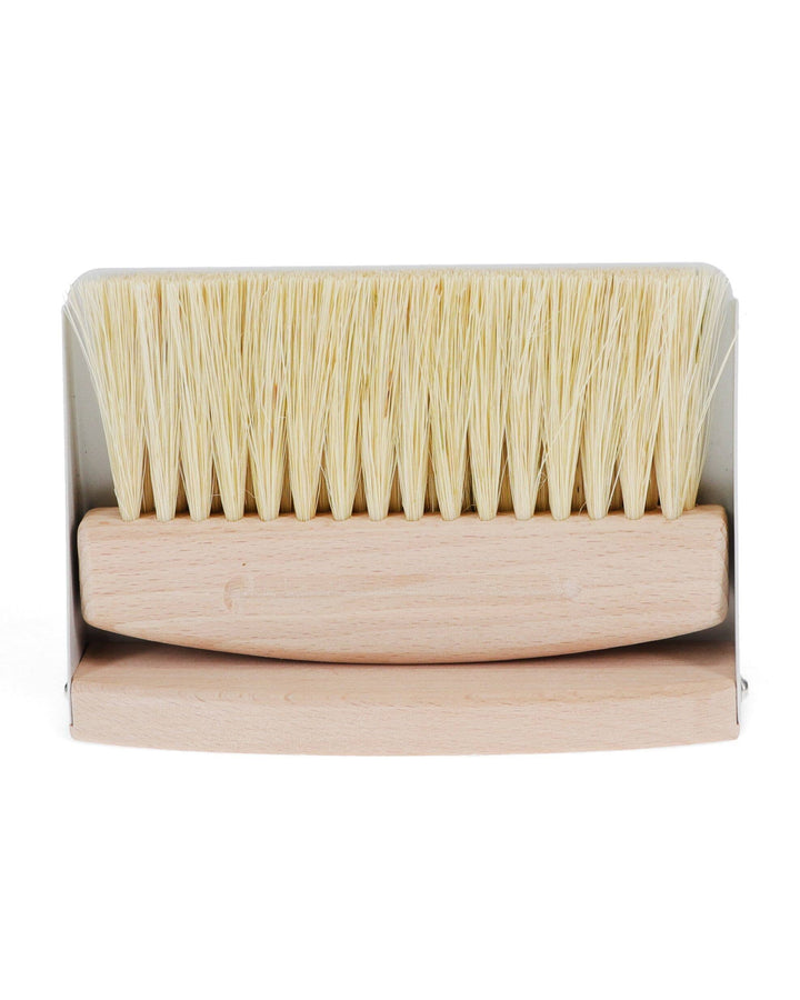 Wooden brush with bristle head in packaging on a white background