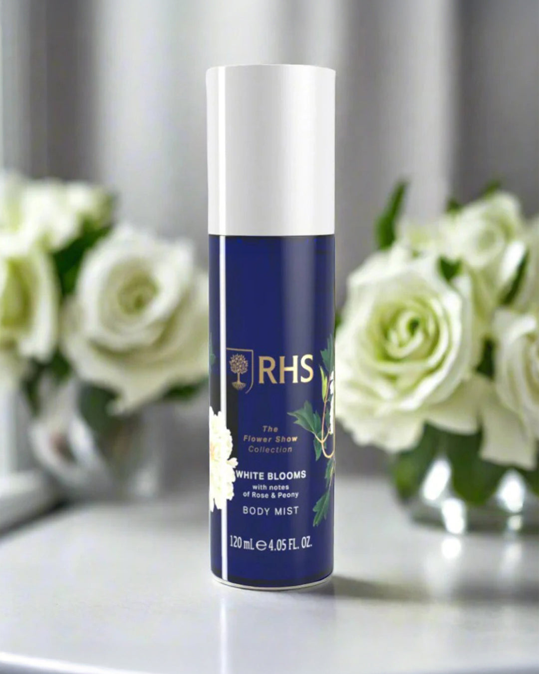 RHS body mist bottle with white flowers in the background