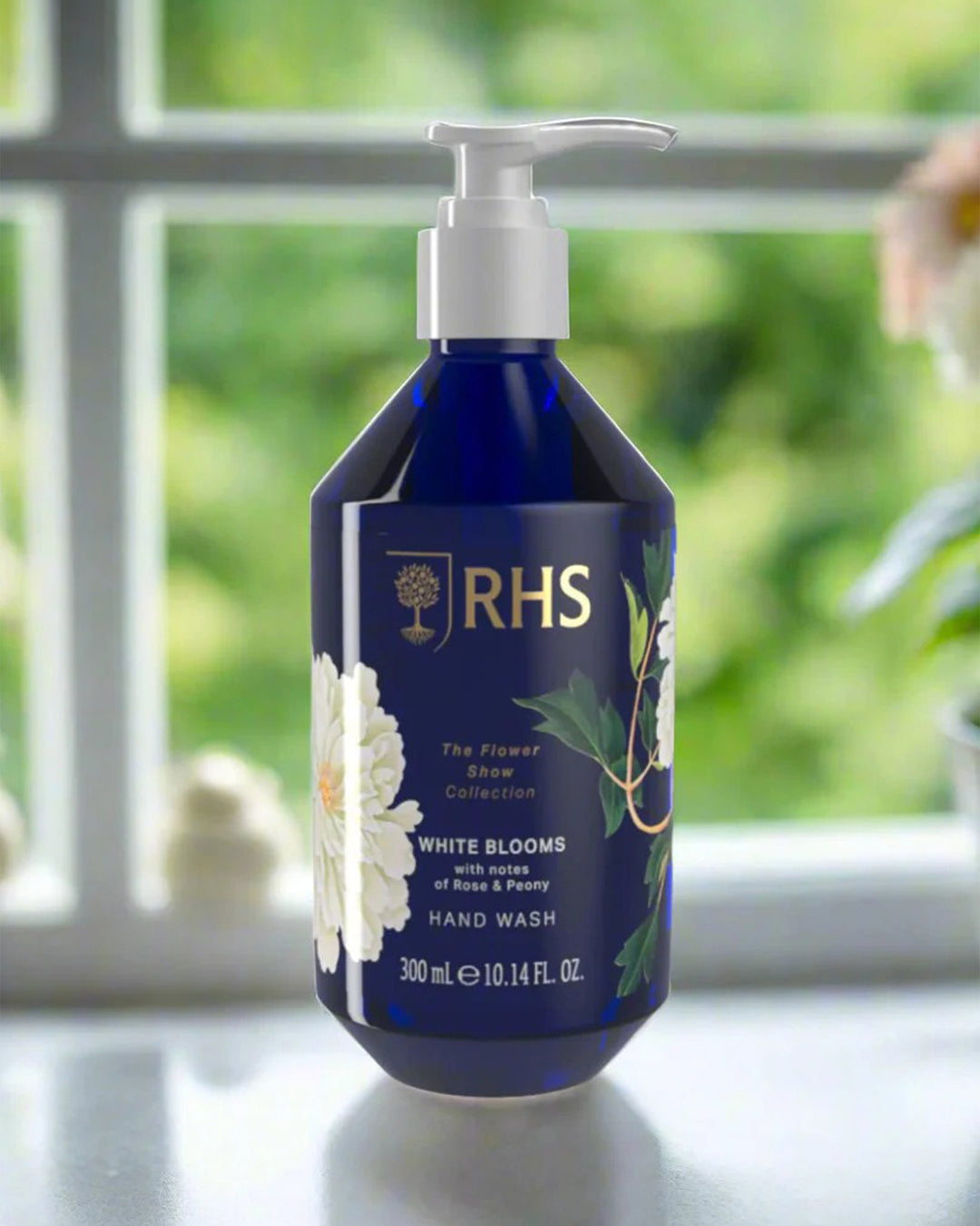 RHS hand wash bottle on a windowsill with greenery outside