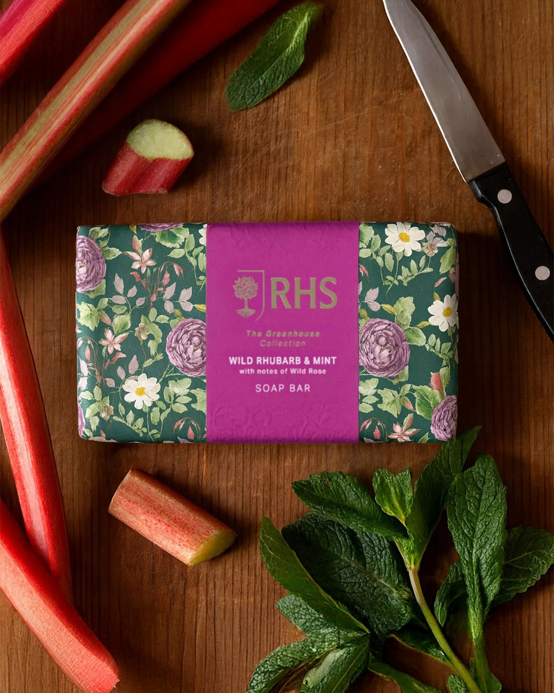 RHS soap bar with rhubarb and mint on a wooden surface