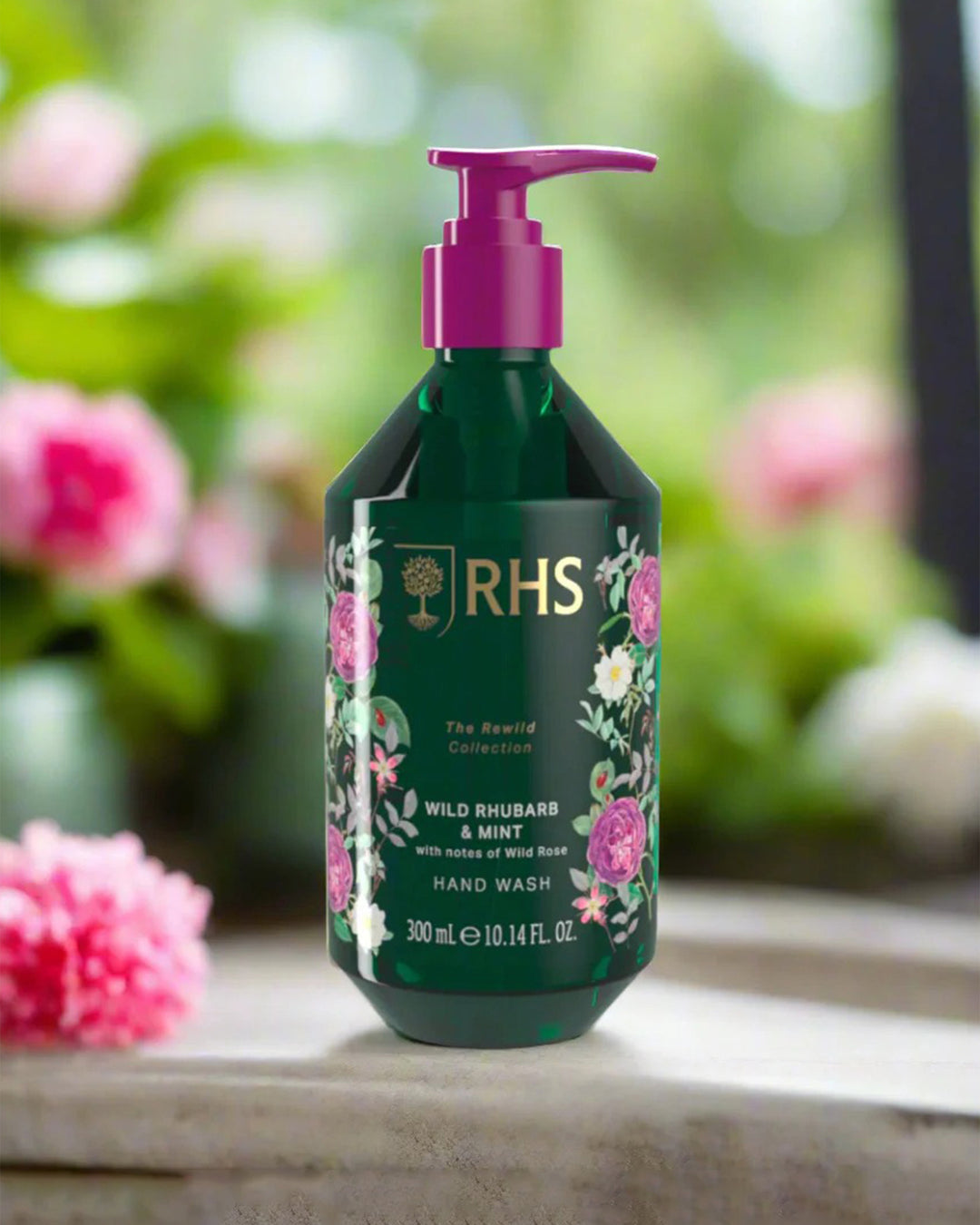 RHS hand wash bottle with floral design on a blurred garden background
