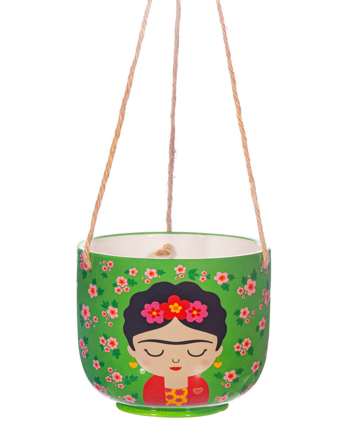 Hanging planter with a design of a face with flowers and floral patterns on a green background.