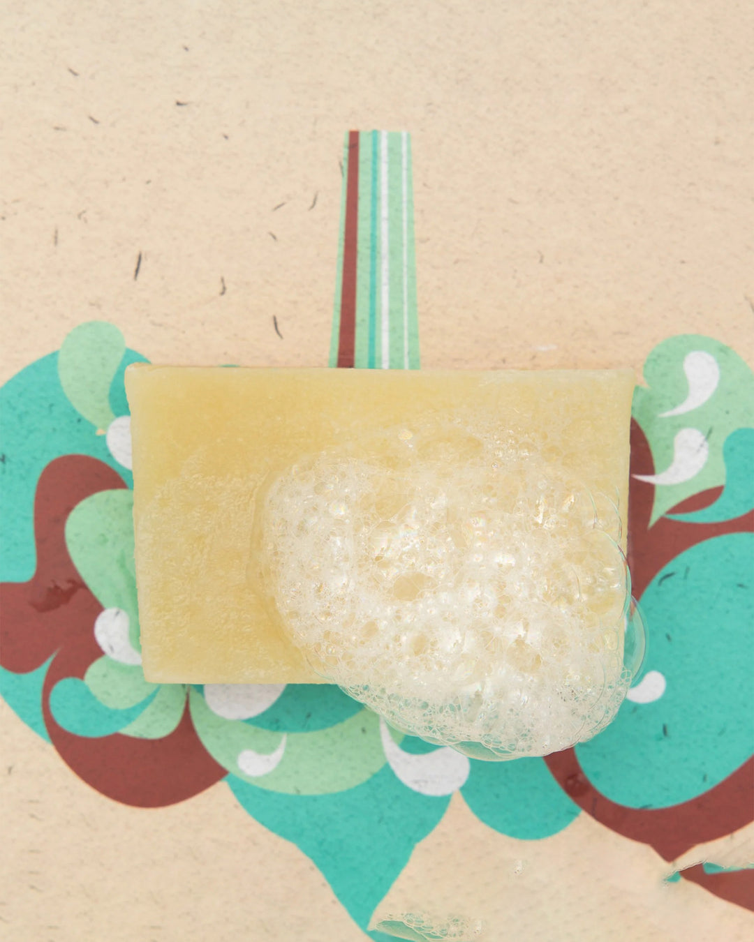 Bar of soap with a textured surface on a decorative background