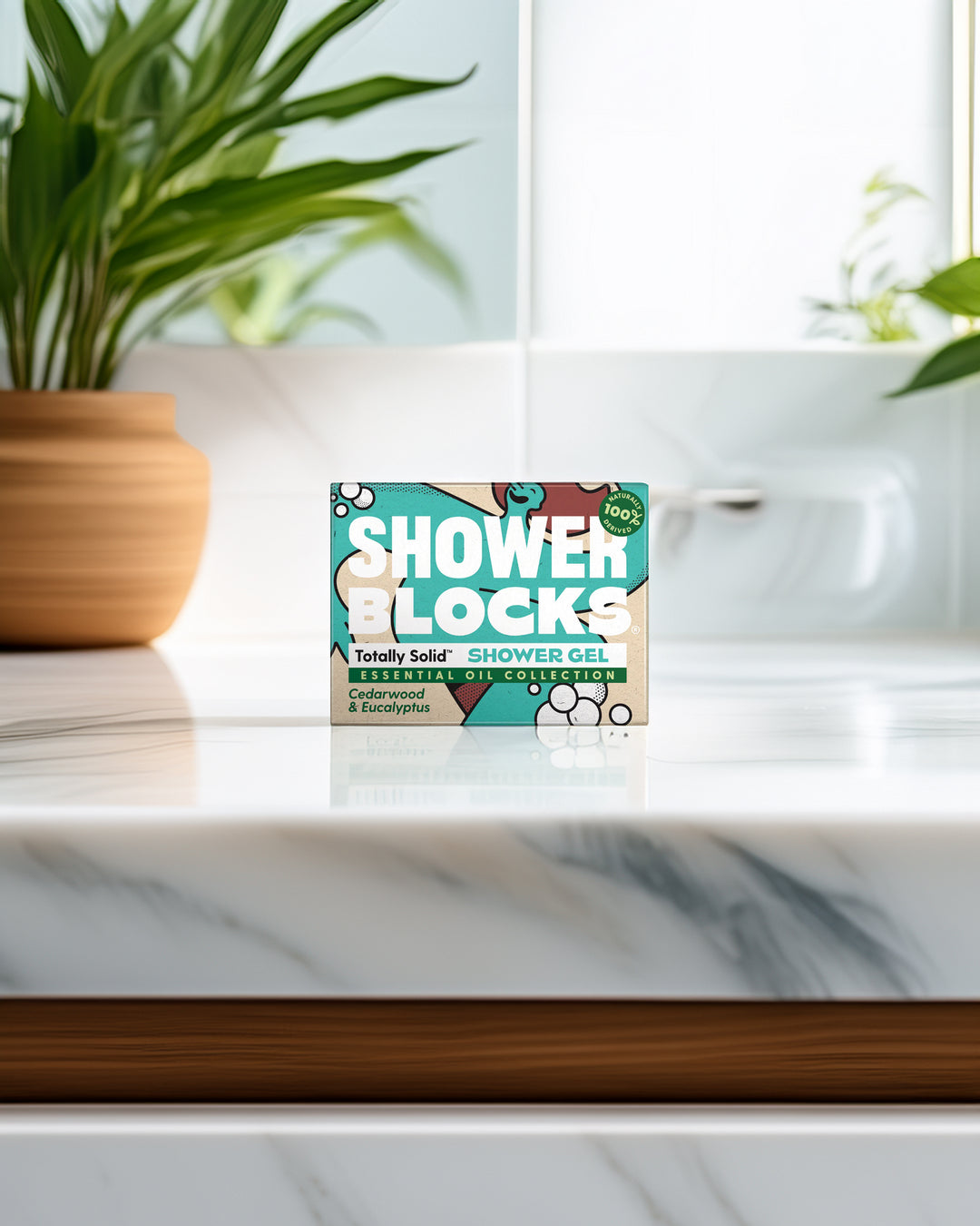 Box of Shower Blocks on a marble surface with plants in the background