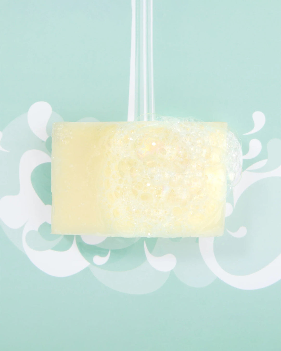 Yellow soap bar with decorative elements on a light blue background